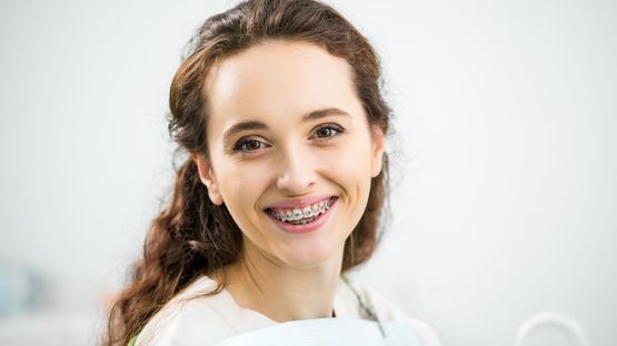 mujer sonriendo con ortodoncia dental